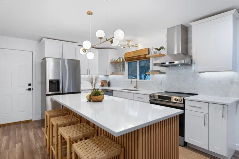 White kitchen with fluted island and pendant lighting