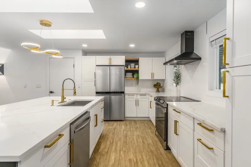 Modern kitchen with gold fixtures and skylight