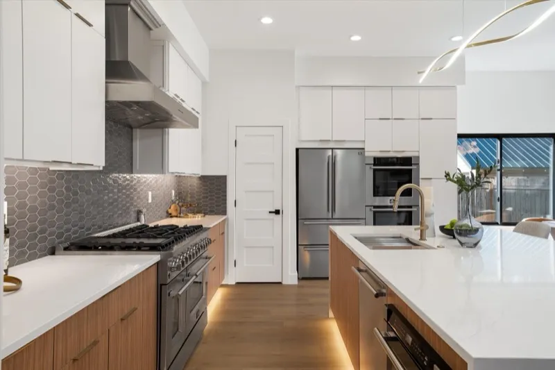Kitchen with hexagon backsplash and walnut cabinets