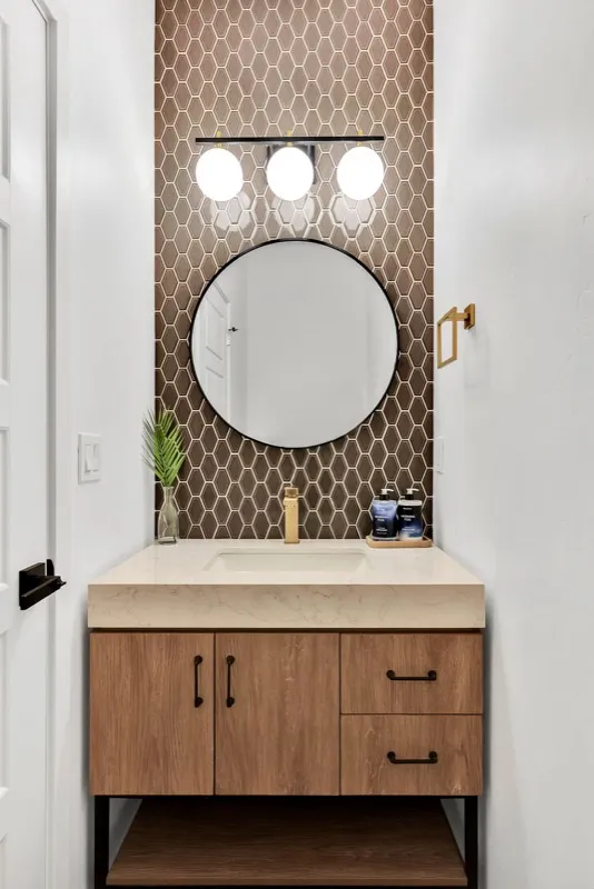 Powder room with brown arabesque accent tile